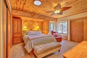 a bedroom with a bed and a ceiling fan at Quiet and Cozy Twain Harte Cabin with Forest View in Twain Harte