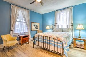 a bedroom with blue walls and a bed and a chair at Peaceful Indianapolis Retreat 20 Min to Dtwn in Indianapolis