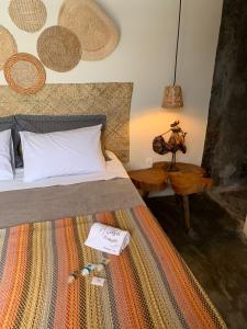 a bedroom with a bed and a table with a lamp at A casa di Maria in Ubatuba