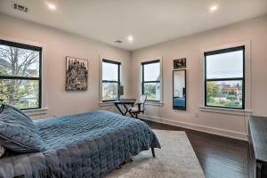 a bedroom with windows and a bed and a desk at Grand Long Branch Home 1 Block to Beach! in Long Branch