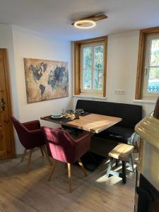 a dining room with a table and chairs and a couch at Steinbachhütte 1 in Drei Annen Hohne