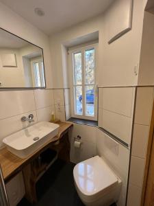 a bathroom with a toilet and a sink and a window at Steinbachhütte 1 in Drei Annen Hohne +16 photos