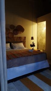 a bedroom with a large bed with a blue mattressvisor at A casa di Maria in Ubatuba