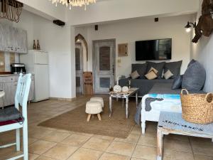 a living room with a couch and a table at ALONI G&A Archaggelos in Archangelos