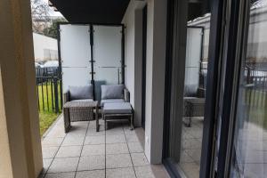 a balcony with two chairs and a table at Hello Kielce in Kielce