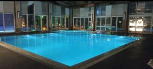a large swimming pool in a building at night at SBK HOTEL in Istanbul