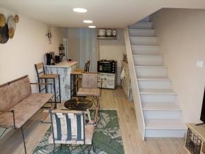a living room with a staircase and a couch at Fira center houses in Fira