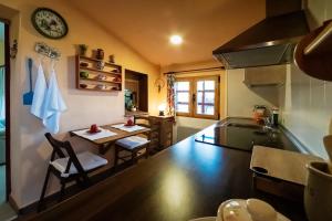 a kitchen with a table and a dining room at Casa Rural El Retiro, rural loft in Buenache de la Sierra