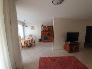 a living room with a table and a television at Eli 2 Sea View apartment first line in Nesebar