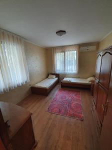 an empty room with two beds and a rug at Eli 2 Sea View apartment first line in Nesebar
