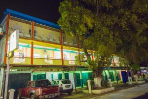 a red truck parked in front of a building at Hotel National Ambilobe in Ambilobe