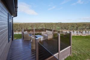 a deck with chairs and a table on a house at Host & Stay - Salt & Seaweed in Runswick
