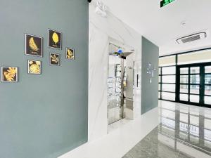 a hallway with paintings on the walls of a building at Myrtle Boutique Hotel Phu Quoc in Phu Quoc