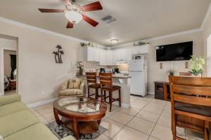 a living room with a couch and a table at Walk to the Beach and Restaurants! - Coconut Villa's Suite 2 in St. Pete Beach