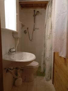 a bathroom with a sink and a toilet and a shower at Le sorgenti - Chalet 42 in Palazzuolo sul Senio