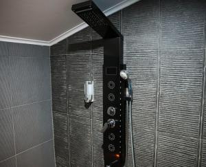 a shower in a bathroom with a glass wall at Le Wellness Privatif in Seraing