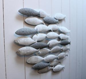a group of fishheads on a wall at Fleur de Ré in Loix
