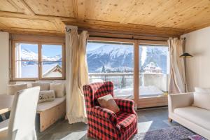 a living room with a view of a mountain at St Moritz 3 Suite vista lago in St. Moritz