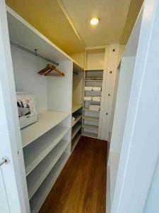 a walk in closet with white walls and wood floors at Apartamento centro de Granada 2 in Granada
