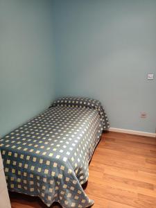a bed in the corner of a room at Habitación privada en casa particular in Albacete