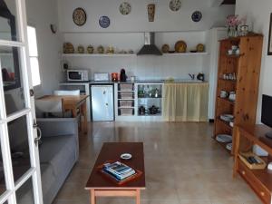 a living room with a couch and a table at Apartamento en Calan Blanes, Ciutadella in Cala en Blanes