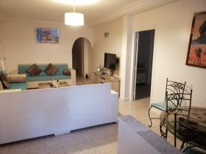 a living room with a couch and a table at Maison à El Omrane . in Tunis