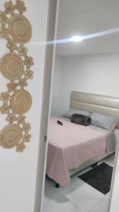 una habitación con una cama con un gato sentado en ella en Viviendas Turísticas Sara Ángel 1, en Salento