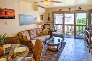 a living room with a couch and tables at Pristine Lihue Condo with Balcony Walk to Beach! in Lihue