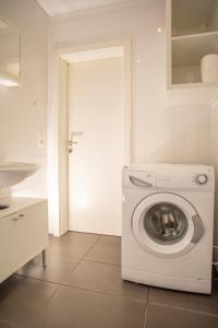 a white washer and dryer in a kitchen at Innsbruck City Center Studio I 24h self-check-in in Innsbruck