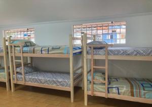 a room with three bunk beds in a room at WR7 Hostel in São Bernardo do Campo