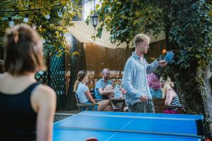 a man standing in front of a ping pong table at T5 Social in Bucharest