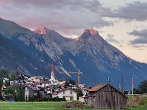 una pequeña ciudad con una montaña en el fondo en Burgerhof en Pettneu am Arlberg