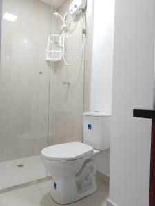 y baño con aseo y ducha. en Apartasuites AAA Modelia Bogotá, en Bogotá