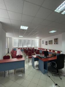 a waiting room with chairs and desks and a laptop at Hotel IN in Banja Luka