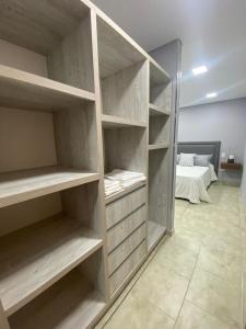 a large closet with empty shelves in a room at PEDROSAS Departamentos in Villa Elisa
