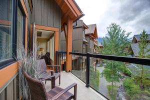 a balcony with chairs and a view of a yard at Misty Mountain- Premium 2 Bedroom Mountain View in Canmore