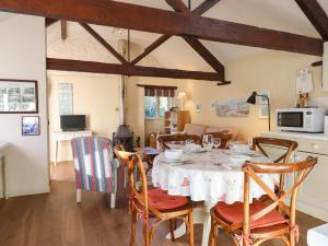 a dining room with a table and chairs at The Calf Pen in Colyton