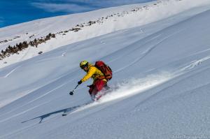 a person is skiing down a snow covered slope at Mine Hostel Dzhergalan in Dzhergalan