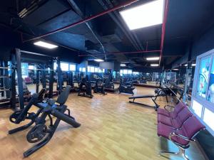 a gym with a lot of treadms and cardio machines at Studio Deira naif in Dubai