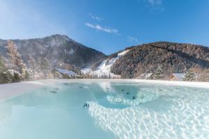 a body of water with mountains in the background at CHALET NORA in San Vigilio Di Marebbe