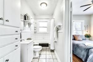 a white bathroom with a bed and a toilet at Global Cup Natural Sabbatical 1 Bedroom Apartment in Dallas