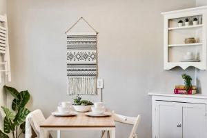 a dining room with a table and chairs at Global Cup Natural Sabbatical 1 Bedroom Apartment in Dallas +13 photos