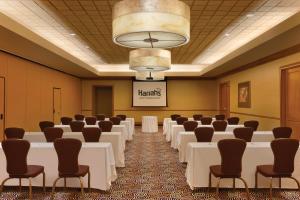 a conference room with white tables and chairs and a chandelier at Harrah's Joliet Casino Hotel in Joliet