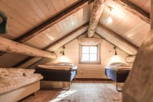 a room with four beds in a attic at Log Cabin from 1820s with wood-heated sauna in Hassela