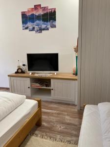 a bedroom with a desk with a television on it at Székelyudvar Fogadó in Lukácsháza
