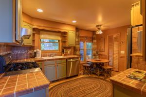 a kitchen with green cabinets and a table at Chipmunk View Lodge in Blowing Rock
