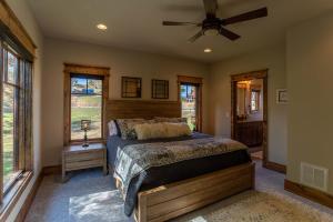 a bedroom with a bed and a ceiling fan at The Sheltered Elk at Eagles Nest in Elk Park