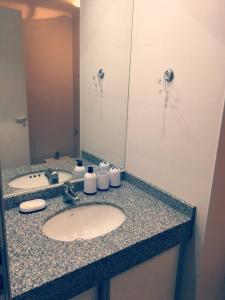 a bathroom counter with two sinks and a mirror at Azucena Apart in Salta