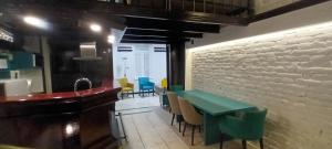 a dining room with a green table and chairs at 10 PERCENT OFF UNTIL 31ST OF OCTOBER - Old Café Spa Apartment in Belgrade