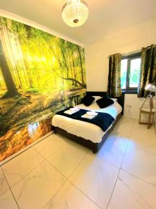 a bedroom with a bed and a painting on the wall at Hunters Hideaway-Hot Tub-Wiltshire-Groups in Warminster